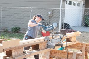 Julia Kaminski Cutting Studs at the Build Site