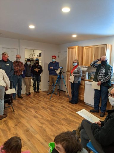 Volunteers gather in the Leaseburg home for the start of the Home Dedication Event