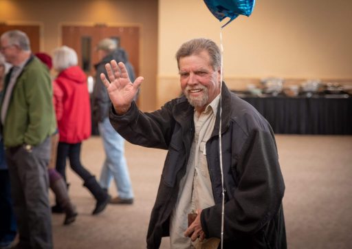 A Beans n Jeans attendee waves as he leaves the event.