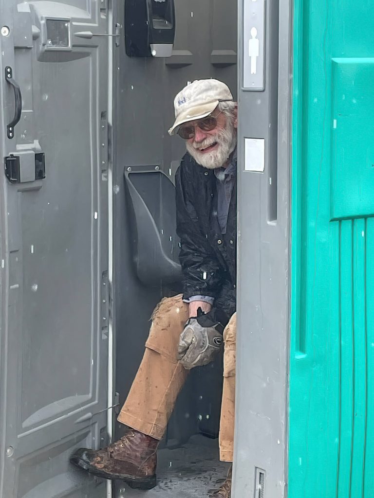 Volunteer Hiding From the Rain at a build site