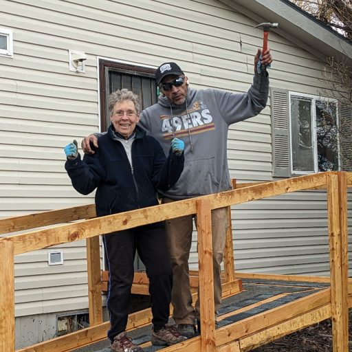 Carolyn Adam and Chet Pitner celebrate the completion of a ramp build.